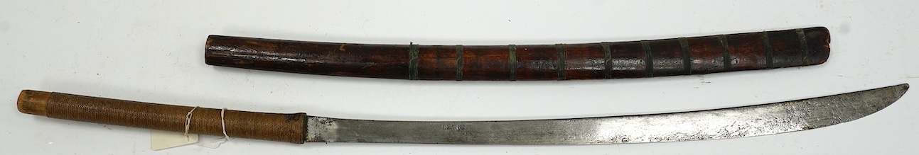 A Burmese sword Dha, curved single edge blade, hilt bound with platted rattan, in its wooden scabbard, blade 60cm. Condition - fair
